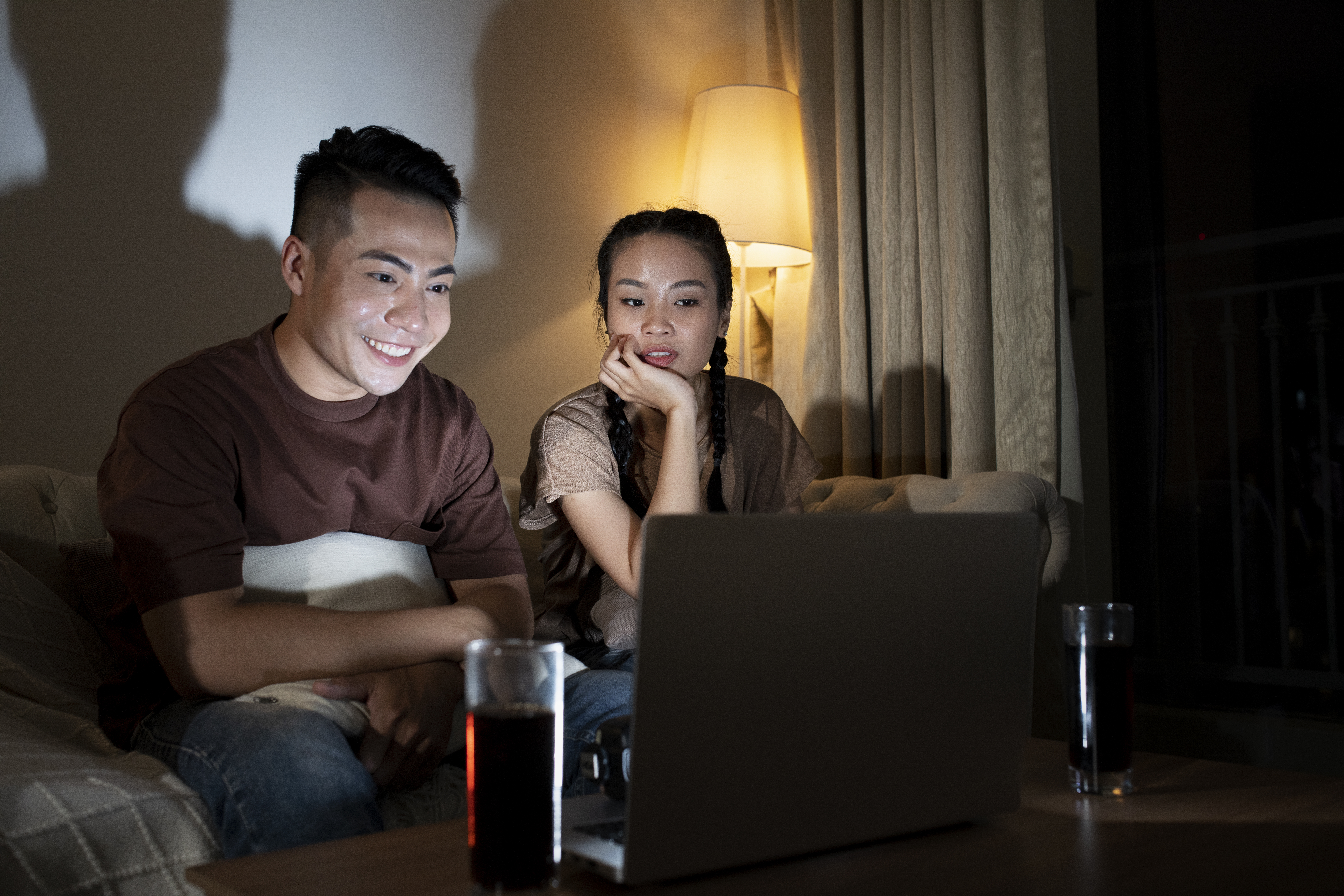 People watching a movie together at home, showing the convenience of having fast and stable home WiFi (WiFi rumah)