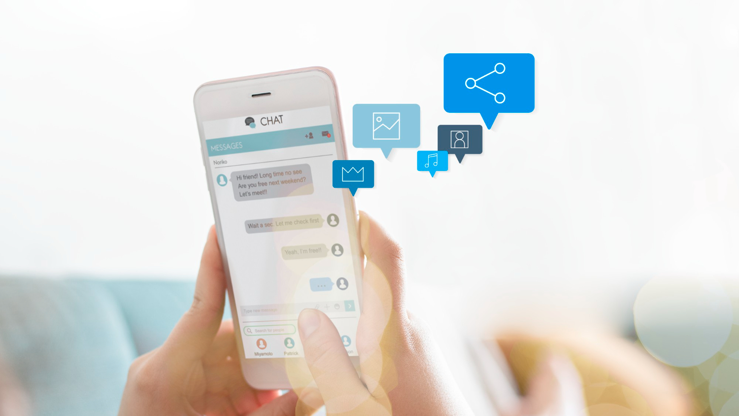 Close-up of a woman’s hands holding a smartphone while typing a message on a chat application.